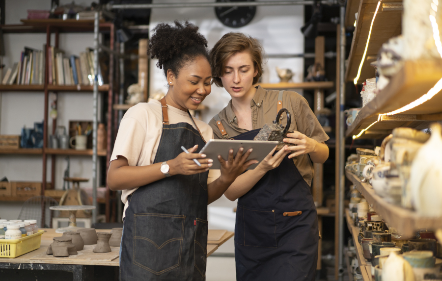 Women look at a tablet.