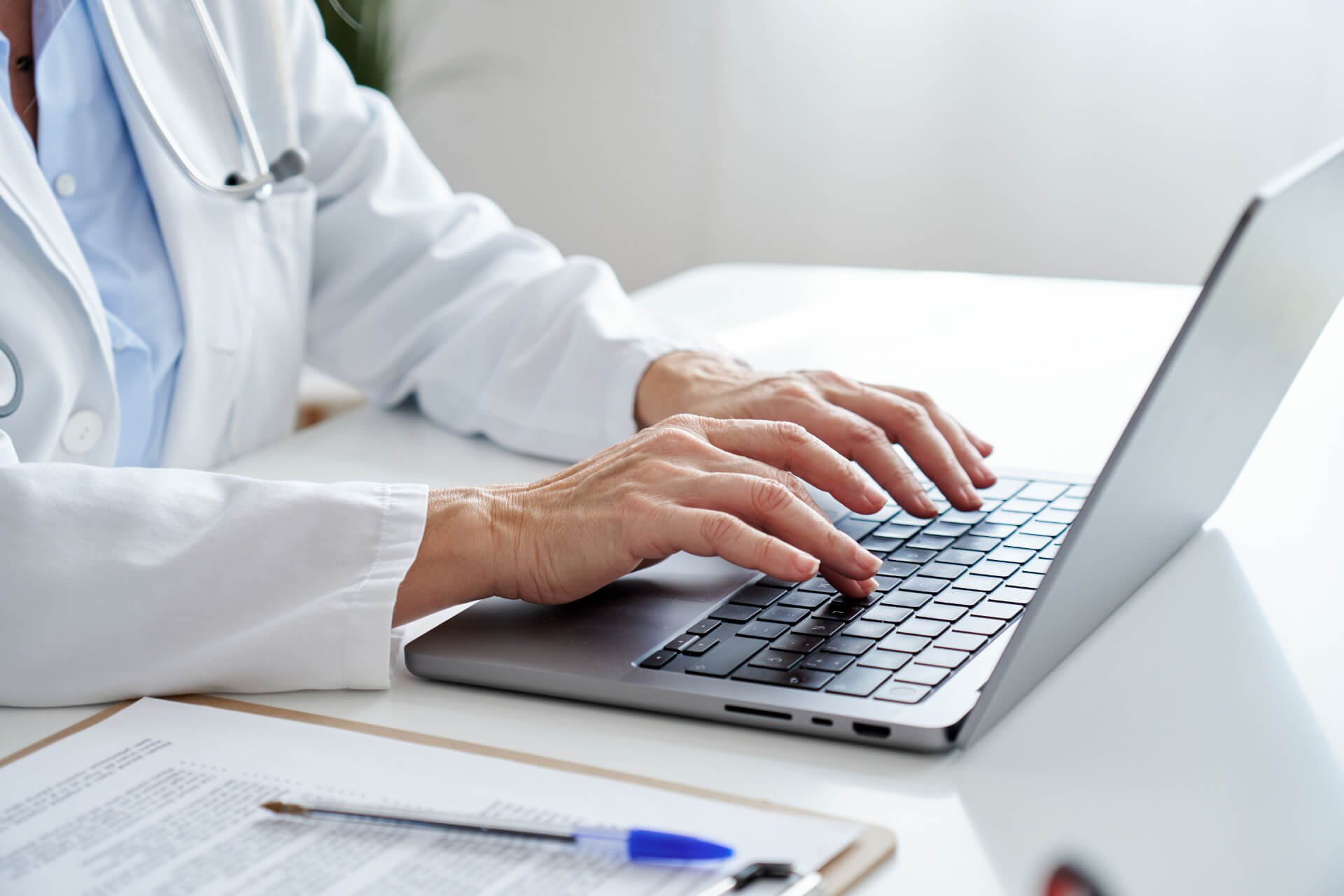 Doctor typing on laptop keyboard