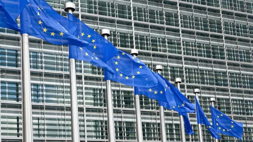 EU flags waving in front of a building.