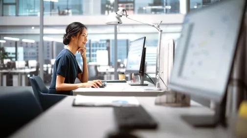 Woman sitting in front of a computer at work.