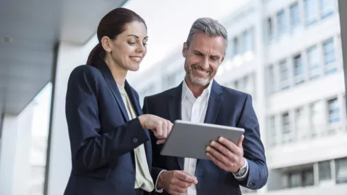 women man tablet suit standing outside