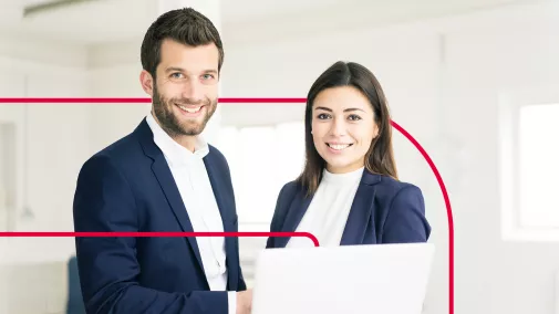 Solutions Business man and woman side by side in front of a laptop
