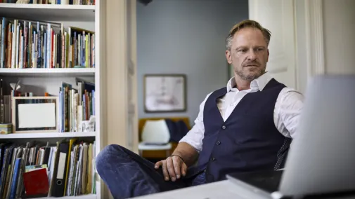 Man with tablet at table working from home 