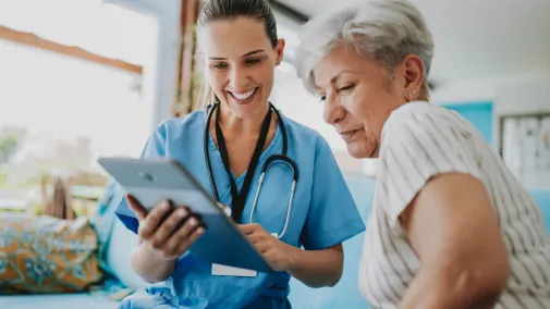 Zwei Frauen blicken auf einen Tablet Computer